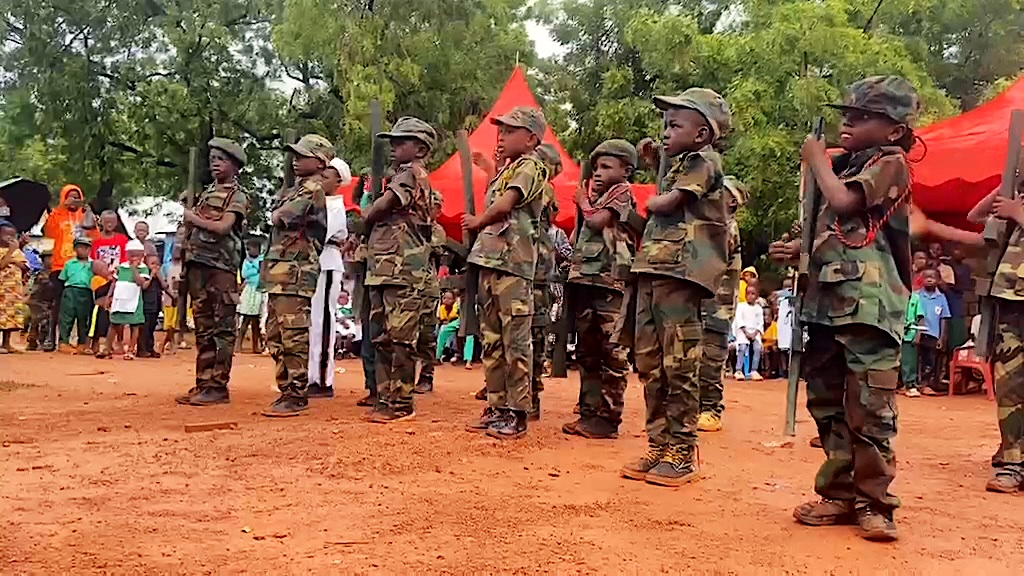 Learners in camouflage costumes marching in step