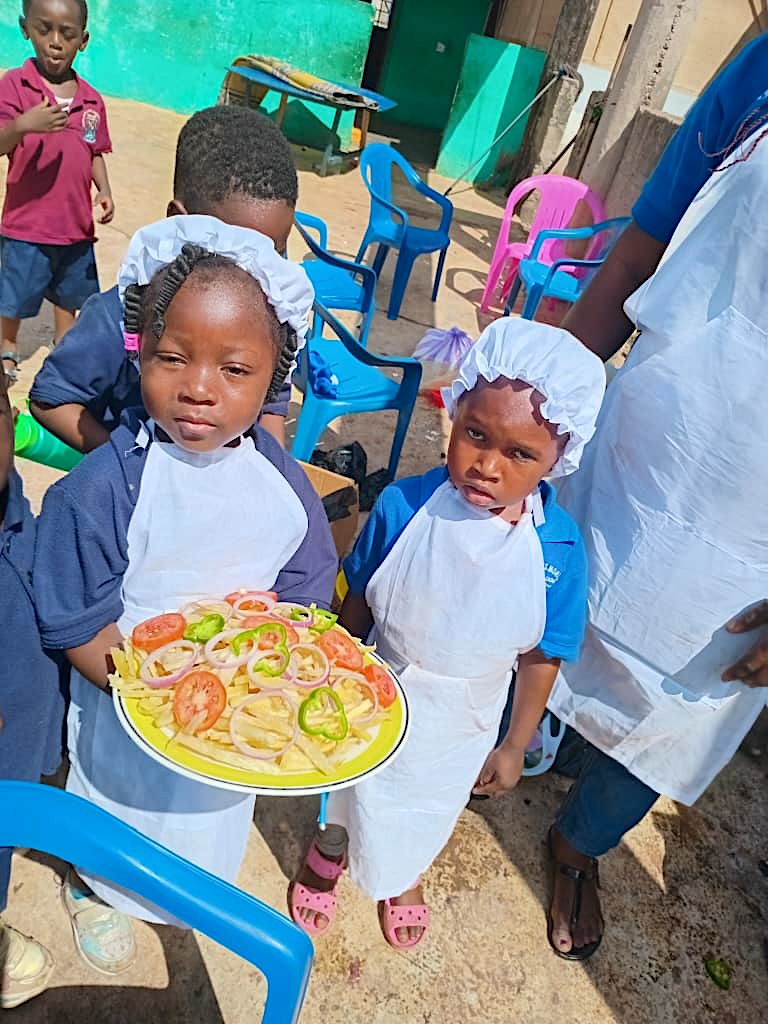 Young chefs holding a plate of salad