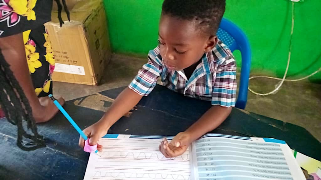 A boy writing in his exercise book