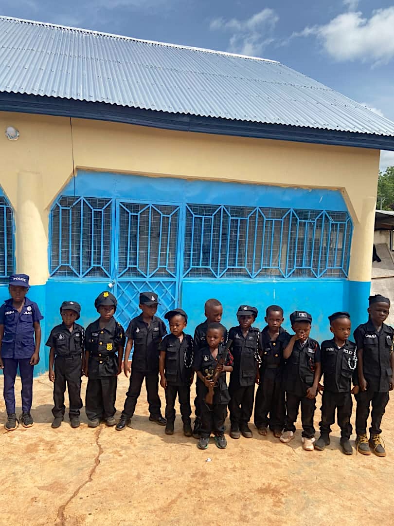 Learners dressed as police officers in front of the school