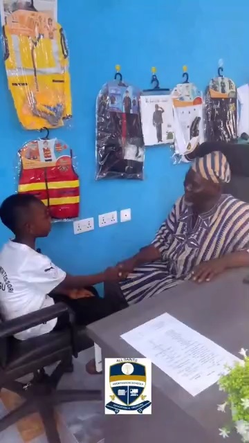 An elder in a smock greeting a learner in an office during Career Week