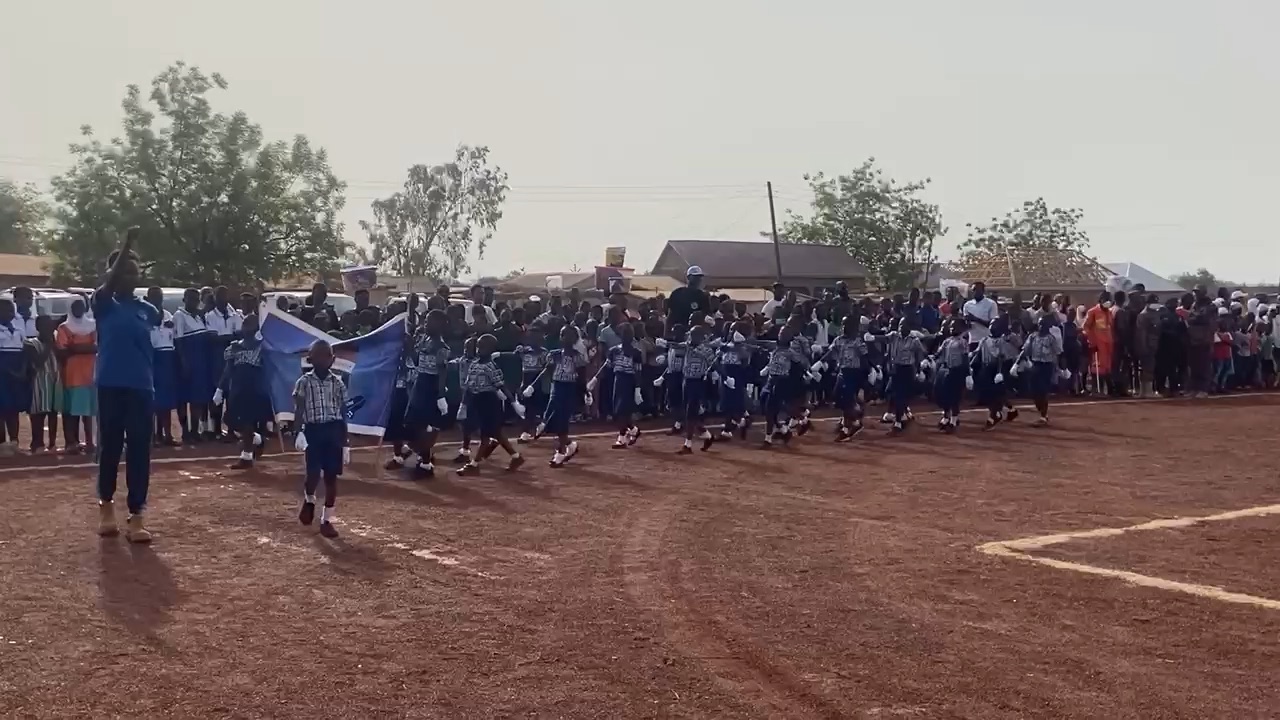 All Saints learners marching past on a sports field