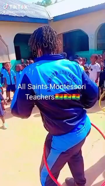 An All Saints teacher in the school tracksuit spinning a hula hoop
